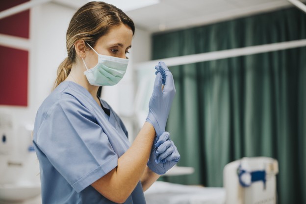 female-nurse-with-mask-putting-gloves (1).jpg